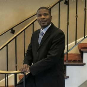 Self-Help borrower, Andre standing beside a staircase